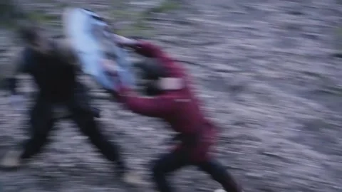 Man in Viking clothes with axes attacks another Viking with sword and shield Video stock 132992353