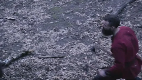 Man in Viking clothes with axes attacks another Viking with sword and shield Video stock 132992373