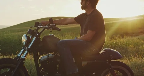 Man on Vintage Motorcycle at Sunset Stock Footage 84236793