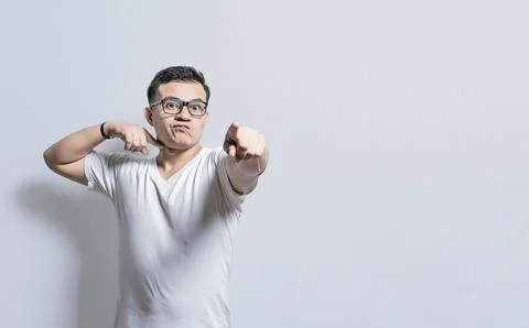A man with a violent look making threatening signs, Person threatening with.. Stock Photos