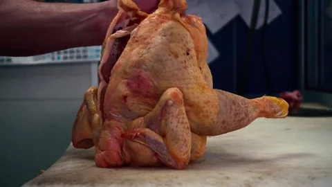 Man violently chopping a chicken in a butcher - 4K Stock Footage