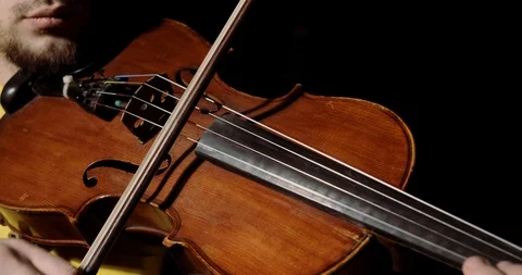 Man violist playing on alt with bow on black background, instrument closeup. Video stock 120841102