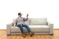 The man in virtual glasses sitting on the sofa on the white wall background Photo