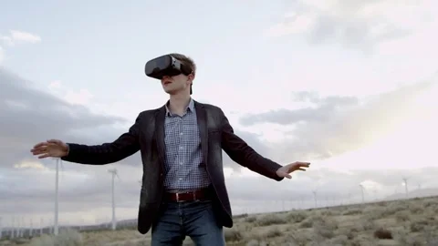 The man in the virtual headset in the countryside Stock Footage 77443980