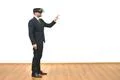 The man with a virtual reality glasses gesturing on the white wall background Photo