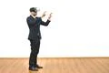 The man with a virtual reality glasses gesturing on the white wall background Photo