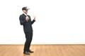 The man with a virtual reality glasses gesturing on the white wall background Photo