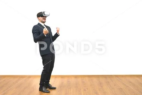 The man with a virtual reality glasses gesturing on the white wall background Stock Photos