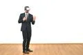 The man in a virtual reality glasses gesturing on the white wall background Photo