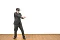 The man in a virtual reality glasses gesturing on a white wall background Photo