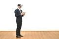 The man with a virtual reality glasses holding a tablet on the white backgrou Photo