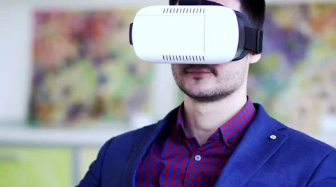 Man in Virtual Reality Glasses. A man in a virtual reality mask looks around. Stock Footage 62828374