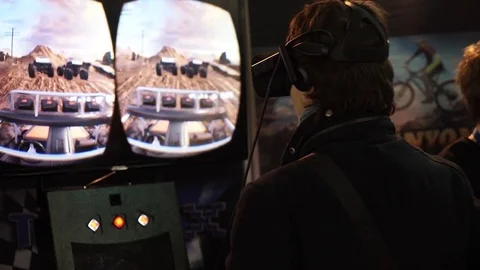 Man in virtual reality glasses playing video game car extreme driving Stock Footage 80875739