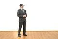 The man in a virtual reality glasses standing on the white wall background Photo