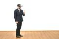The man with a virtual reality glasses thumbs up on the white wall background Photo