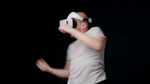 Man in in virtual reality head-mounted display boxing with shadow Stock Footage 75178195