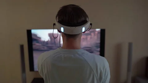 Man with virtual reality headset and joystic is playing game Stock Footage 172436398