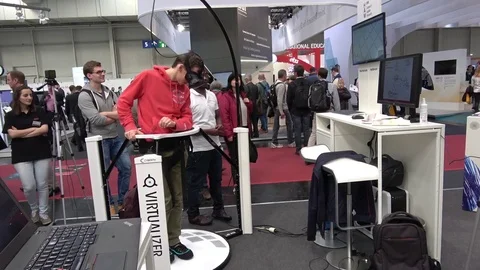 Man in virtual reality headset on Cyberith Virtualizer on exhibition Cebit 2017 Stock Footage 74571853