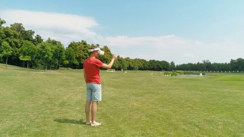 A man with virtual reality headset on his head is standing and using VR helmet Stock Footage 114484048