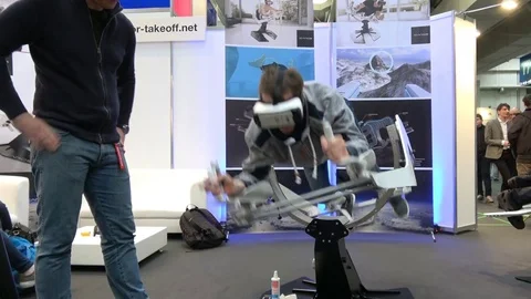 Man in virtual reality headset on Icaros company stand on exhibition Cebit 2017 Stock Footage 77269329