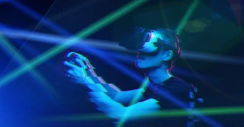 Man with virtual reality headset is playing game. Image with glitch effect. Stock Photos