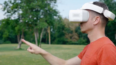 A man in a virtual reality helmet controls gestures Stock Footage 128829628