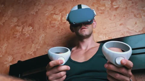 Man in a Virtual Reality Helmet Controls the Controllers Video stock 201206746