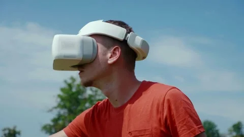 Man in a virtual reality helmet is studying a virtual game Stock Footage 134601195
