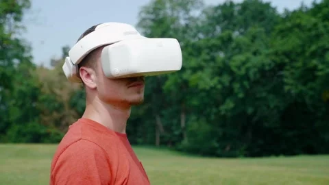 Man in a virtual reality helmet turns his head to the right Stock Footage 130489096