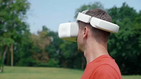 Man in a virtual reality helmet turns head to the right Stock Footage 133485356