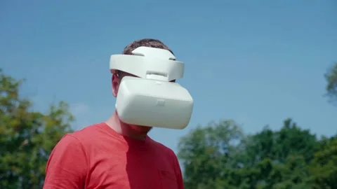Man in a virtual reality helmet turns head down and to the right Stock Footage 133485357