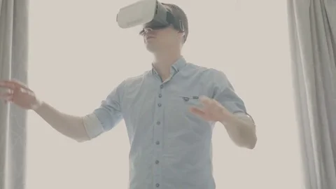 Man in a virtual reality mask looks around. Stock Footage 80696648