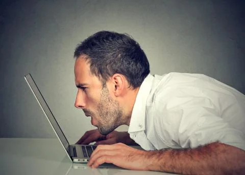 Man with vision problems using computer reading email browsing internet Stock Photos