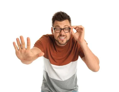 Man with vision problems wearing glasses on white background Stock Photos