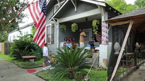 Man visiting with neighbor on his front porch Stock Footage