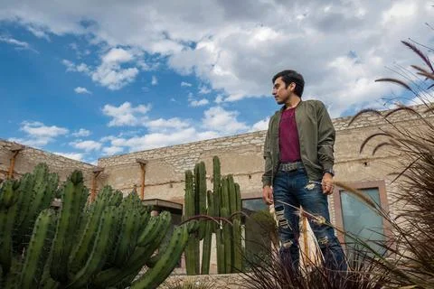 Man visiting the old rustic model school with cactus in Mineral de Pozos Gu.. Stock Photos