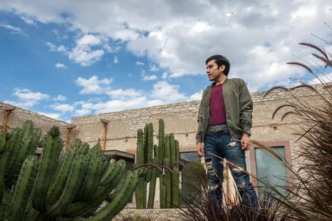Man visiting the old rustic model school with cactus in Mineral de Pozos Gu.. Stock Photos