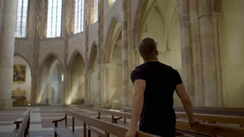 A man visits and observes an old church in Toulouse, France Stock Footage 210764338