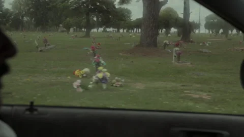 Man visits graveyard to pay respects on a cloudy afternoon Stock Footage 327960866