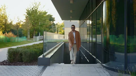 Man with visual disability using stick while walking Stock Footage 182391156