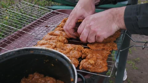 Man with Vitiligo Placing Marinated Chicken on Bbq Grill Grate Stock Footage 334121083