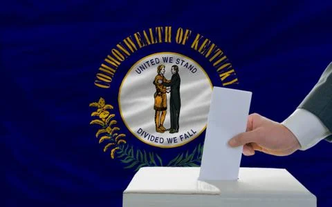 Man voting on elections in front of flag us state flag of kentucky Stock Photos