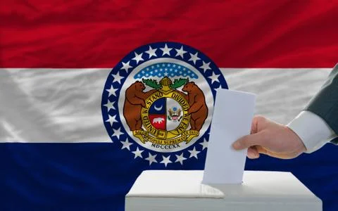 Man voting on elections in front of flag us state flag of missouri Stock Photos