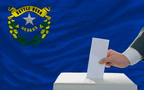 Man voting on elections in front of flag us state flag of nevada Stock Photos