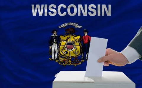 Man voting on elections in front of flag us state flag of west wisconsin Stock Photos