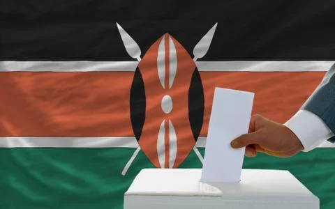 Man voting on elections in kenya in front of flag Stock Photos