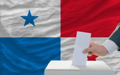 Man voting on elections in panama in front of flag Stock Photos