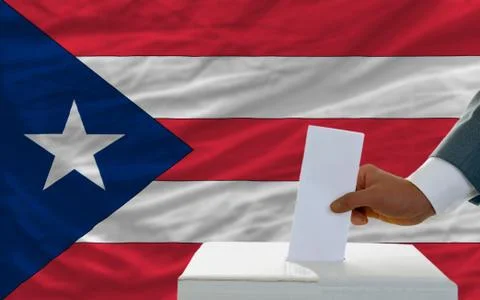 Man voting on elections in puertorico in front of flag Stock Photos