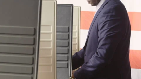 Man voting in a voting booth, pan up shot Video stock 66252217