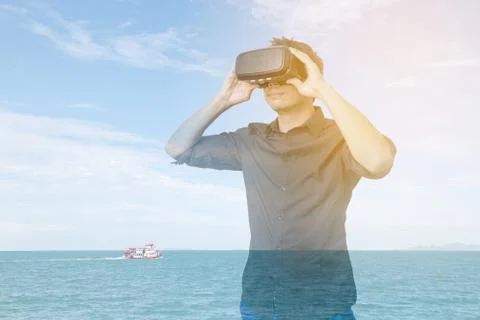 Man in a VR glasses operating in virtual reality ocean Stock Photos